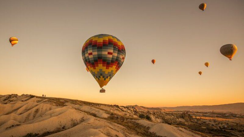 hot-air-balloons-hills-fields-sunset-cappadocia-turkey_181624-20680